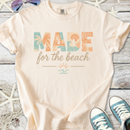 Light peach cotton t-shirt with 'MADE for the beach' graphic, perfect for casual beachwear.