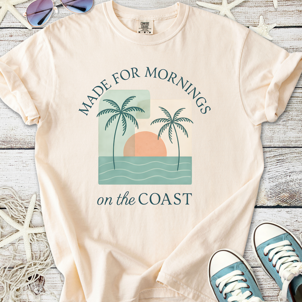 Peach beach-themed t-shirt with palm trees and sunset graphic, perfect for coastal mornings.