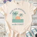 Peach beach-themed t-shirt with palm trees and sunset graphic, perfect for coastal mornings.