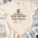 Light peach t-shirt with 'Fueled by Iced Coffee & Sea Breeze' graphic, soft cotton material.