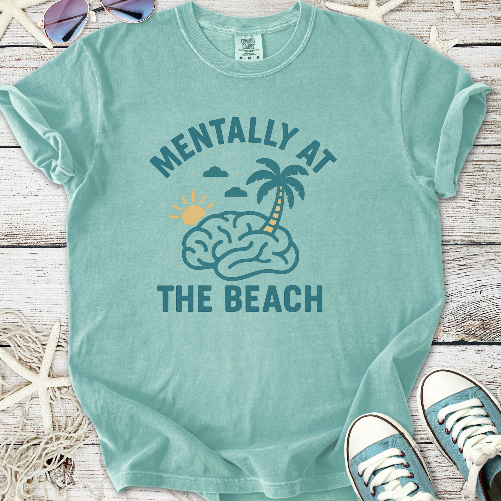 Mint green t-shirt with 'Mentally at the Beach' graphic, featuring brain, sun, and palm tree design.
