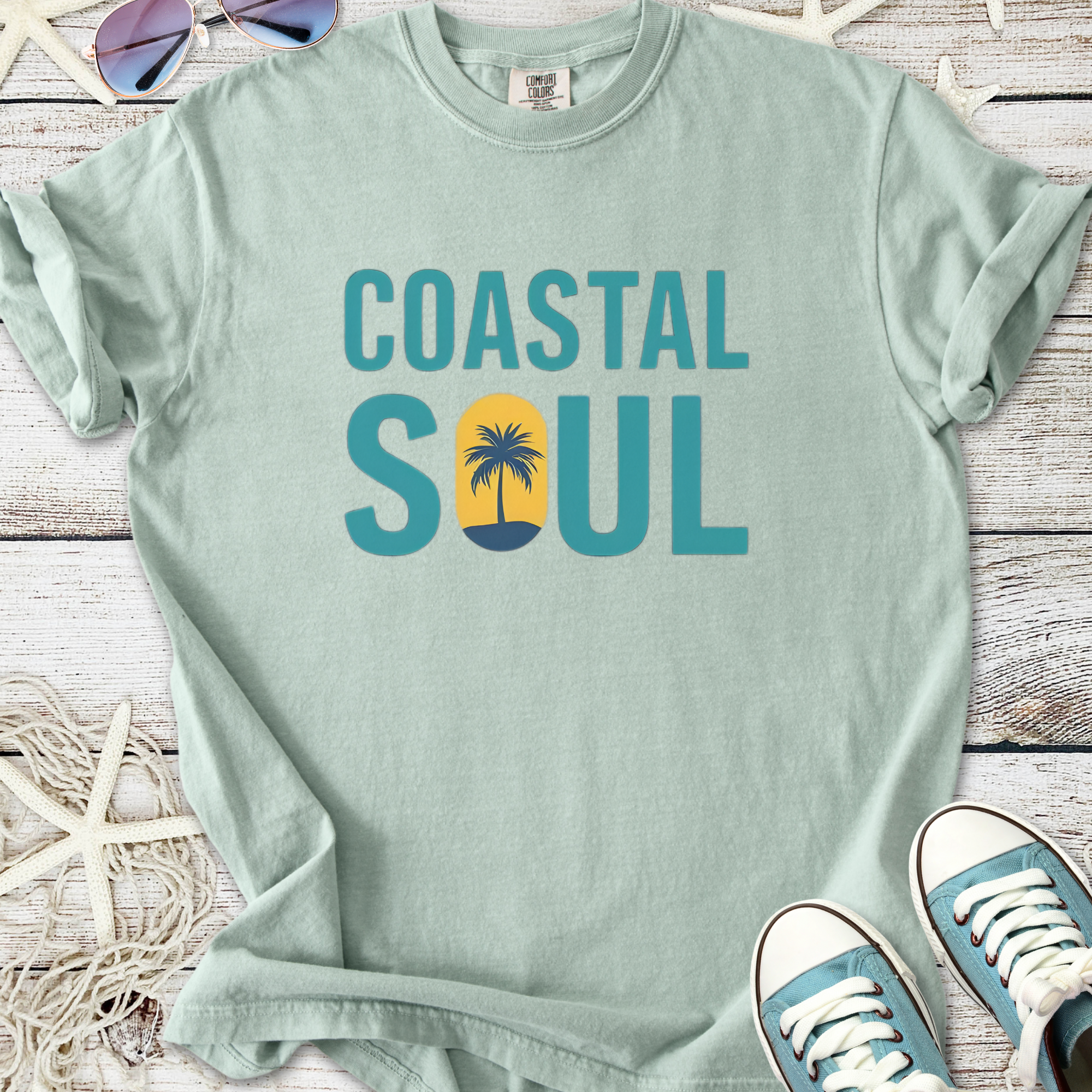 Mint green Coastal Soul t-shirt featuring palm tree design, perfect for beach lovers.