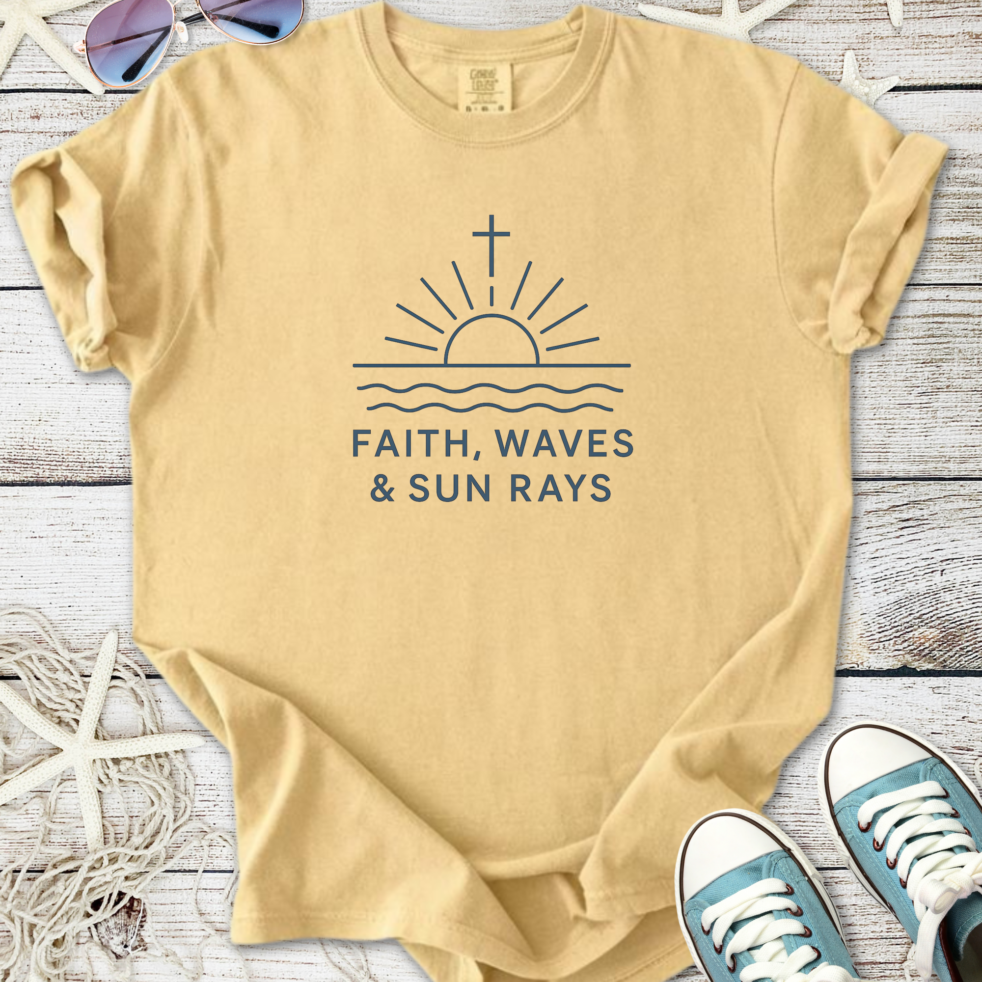 Beige cotton t-shirt featuring a sun and waves graphic with the phrase 'Faith, Waves & Sun Rays'