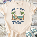Beige graphic t-shirt with beach design and 'Does this shirt make me look retired?' text.