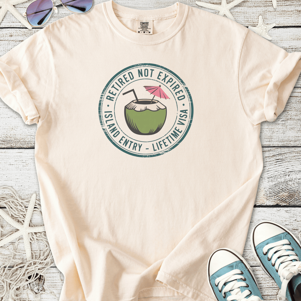Cream retirement beach themed graphic t-shirt with coconut drink and ‘Retired Not Expired — Lifetime Visa’ text