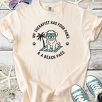 Light peach t-shirt featuring a cute dog graphic with sunglasses and beach theme text.