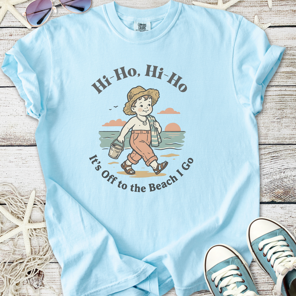 Light blue t-shirt featuring a vintage beach graphic with a child, perfect for summer outings.