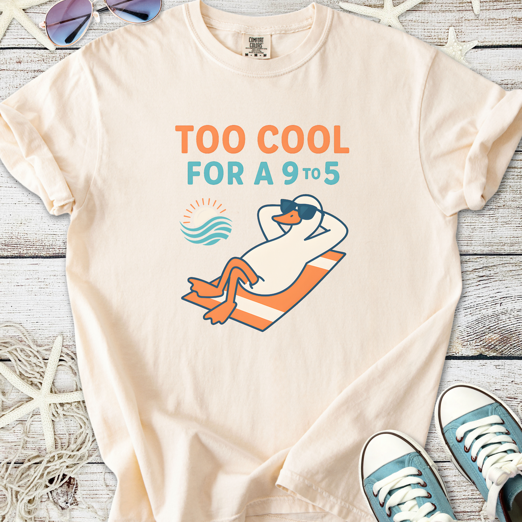 Cream unisex t-shirt featuring a relaxed penguin graphic and the phrase 'Too Cool for a 9 to 5'.