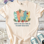 Light tan t-shirt with surfboard graphic and 'Too Many Beach Days' text, perfect for beach lovers.