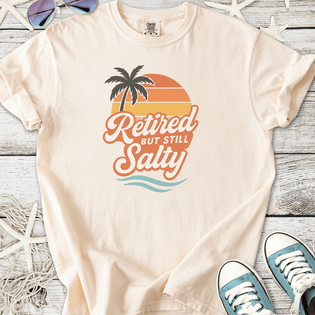 Cream cotton t-shirt with 'Retired But Still Salty' graphic and palm tree design.
