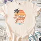 Cream cotton t-shirt with 'Retired But Still Salty' graphic and palm tree design.