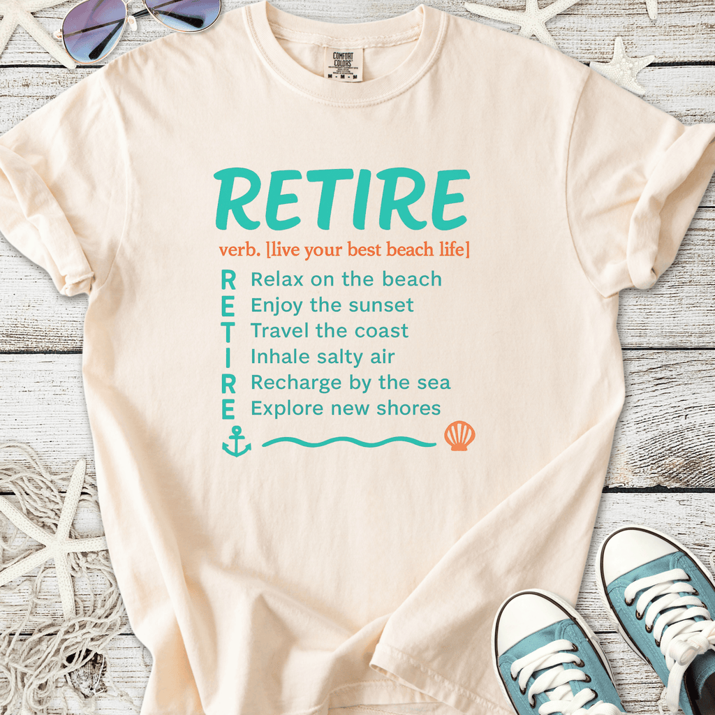 Cream beach-themed t-shirt with 'RETIRE' graphic and seaside phrases. Perfect for casual summer wear.