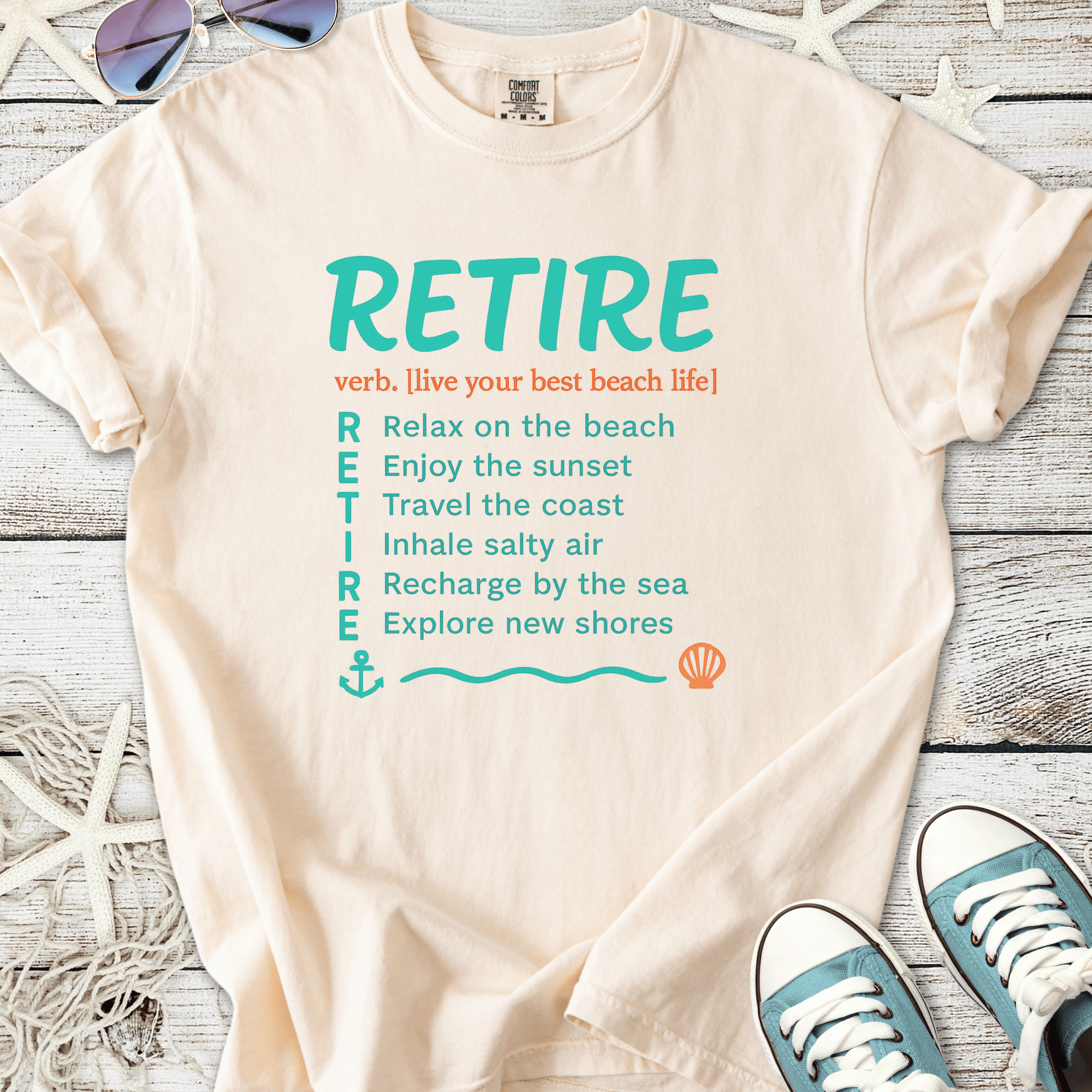 Cream beach-themed t-shirt with 'RETIRE' graphic and seaside phrases. Perfect for casual summer wear.