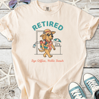 Cream cotton t-shirt featuring a cartoon dog with sunglasses and the text 'Retired, Bye Office, Hello Beach'