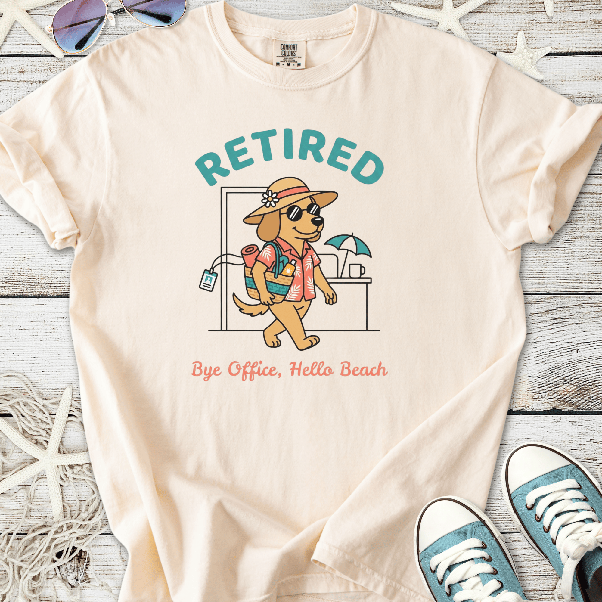 Cream cotton t-shirt featuring a cartoon dog with sunglasses and the text 'Retired, Bye Office, Hello Beach'