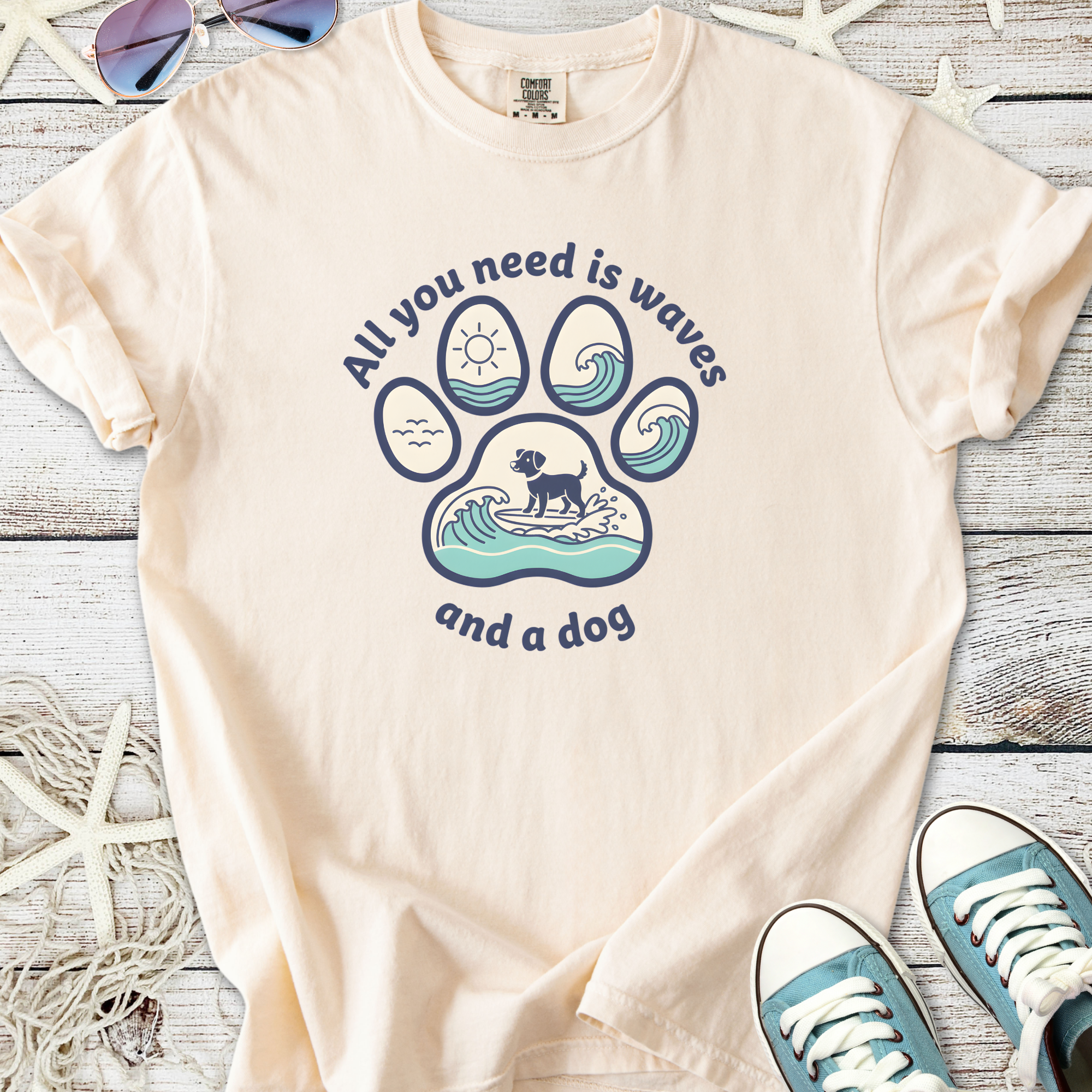 Cream graphic tee with dog and wave design, perfect for beach lovers and pet owners.