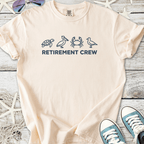 Cream retirement t-shirt featuring turtle, pelican, crab, and bird graphics. Perfect for relaxed celebrations.