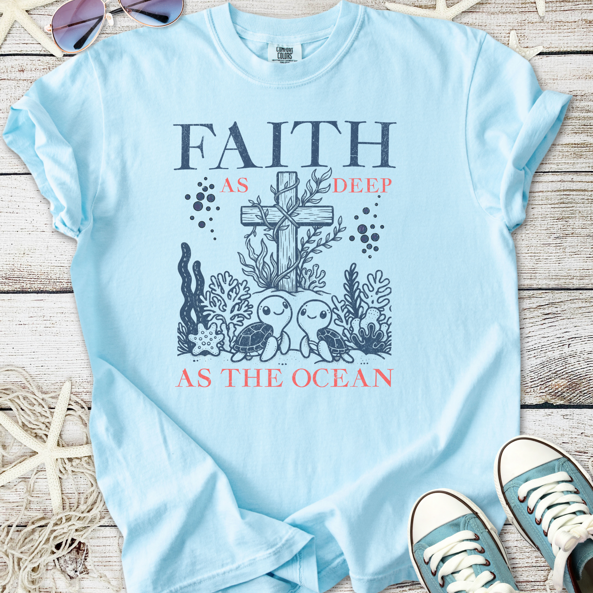 Light blue t-shirt featuring a faith-themed ocean design with turtles and coral.