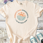 Cream cotton t-shirt with 'Sunsets Over Spreadsheets' graphic, perfect for retirees.