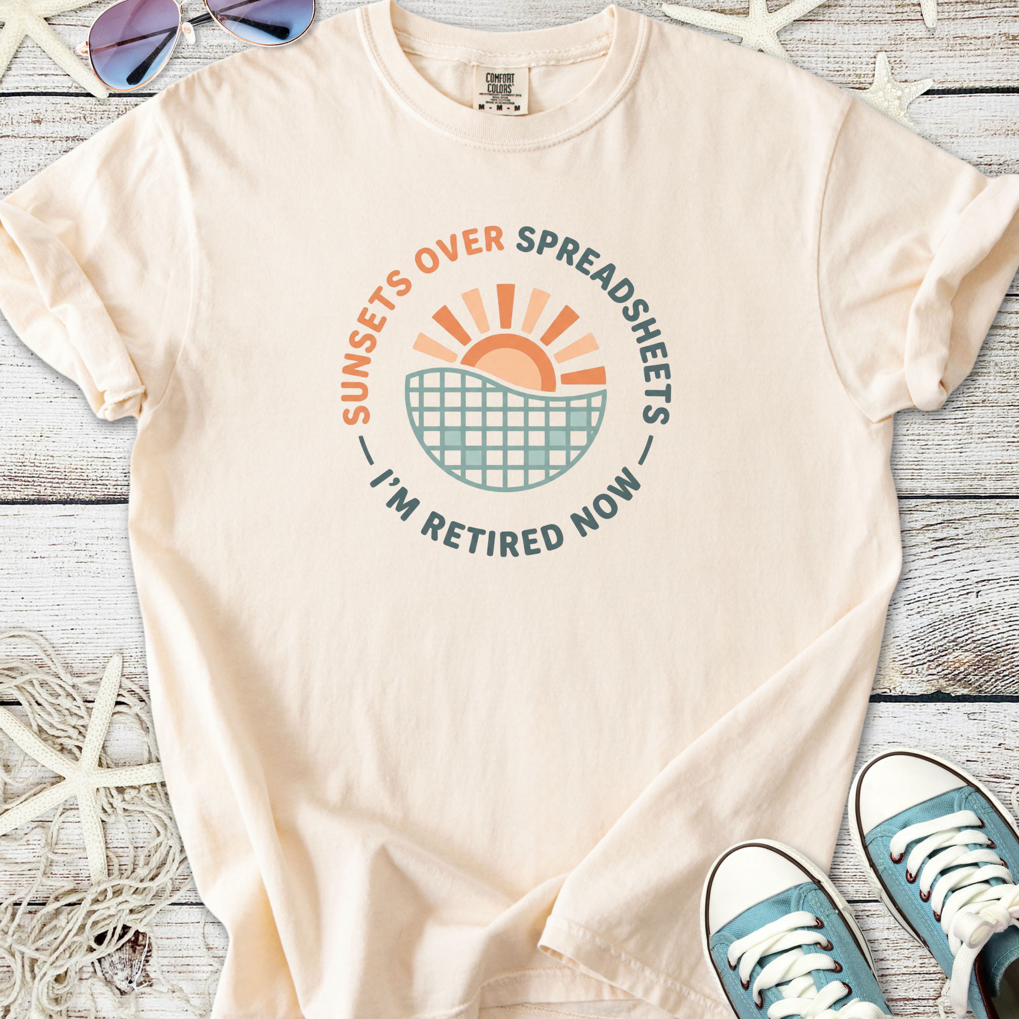 Cream cotton t-shirt with 'Sunsets Over Spreadsheets' graphic, perfect for retirees.