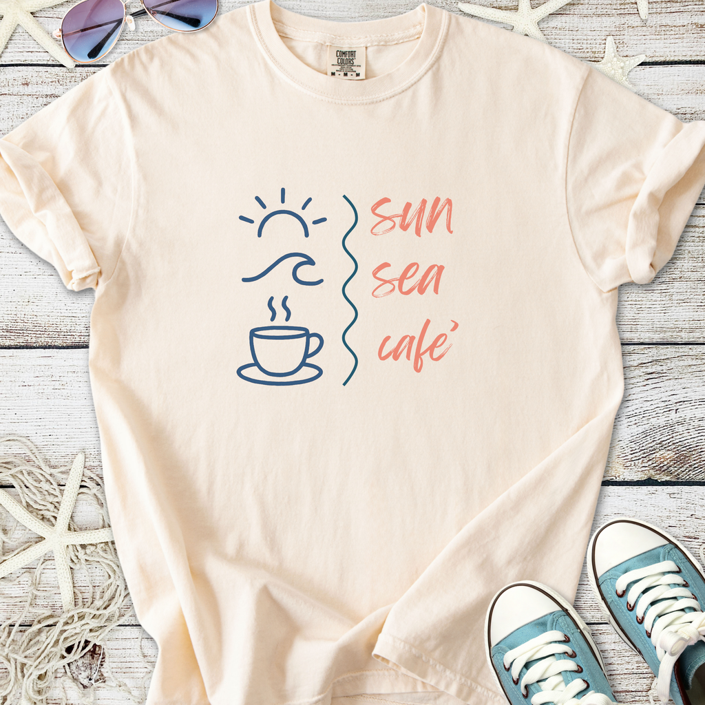 Light beige t-shirt with 'sun sea café' graphic, featuring coffee cup, sun, and wave designs.