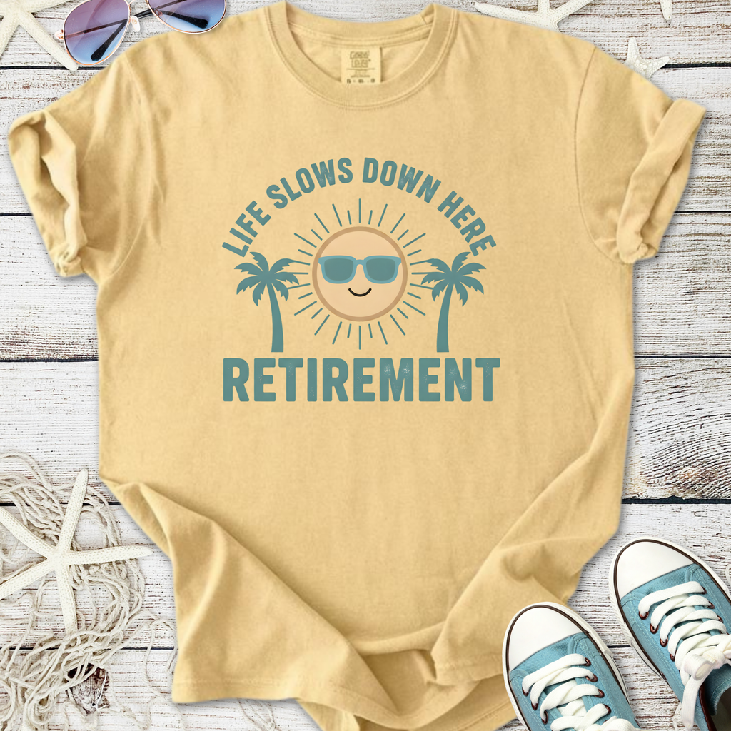 Beige cotton t-shirt with 'Life Slows Down Here Retirement' graphic and sun design.