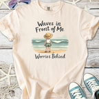 Light beige t-shirt with children's beach graphic text, featuring 'Waves in Front of Me, Worries Behind'.