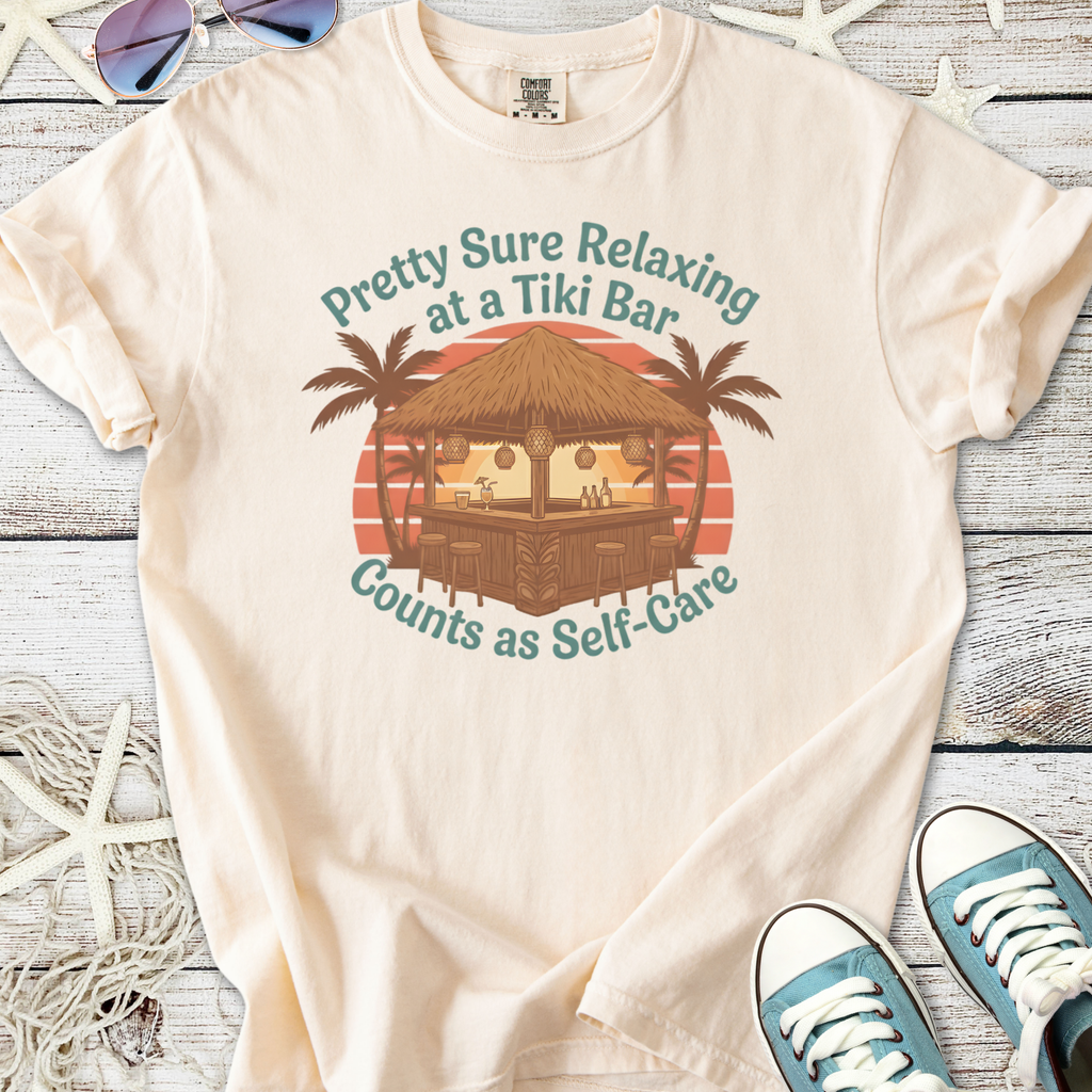 Cream cotton t-shirt featuring tiki bar graphic with palm trees, text 'Counts as Self-Care'.