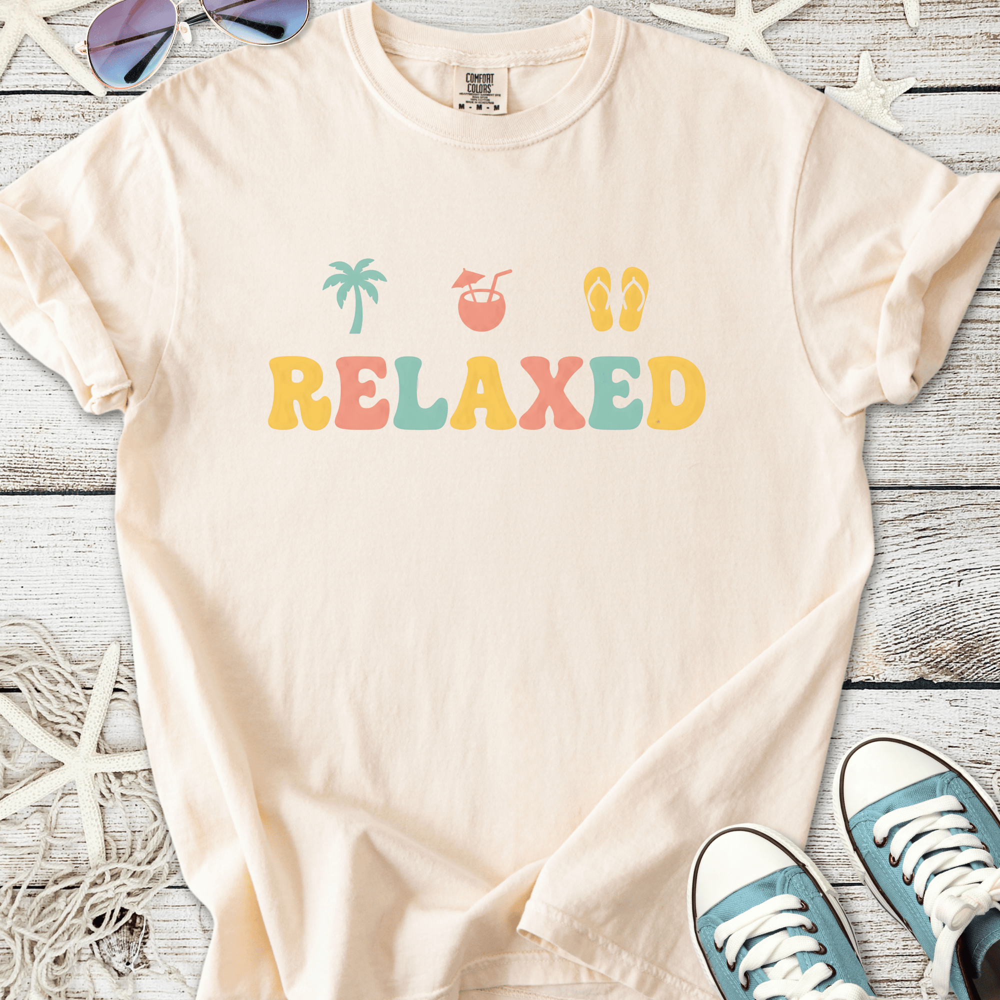 Beige cotton t-shirt with colorful 'RELAXED' graphic, perfect for casual summer wear.