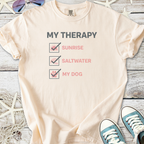 Light peach t-shirt with 'My Therapy' graphic featuring sunrise, saltwater, and dog motifs