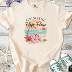 Cream t-shirt with 'Living the Flip Flop Life' graphic, featuring pink flip flops and beach elements.