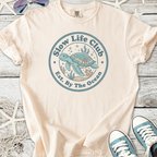 Beige cotton t-shirt featuring 'Slow Life Club' turtle graphic, ocean-themed design, perfect for beach lovers.