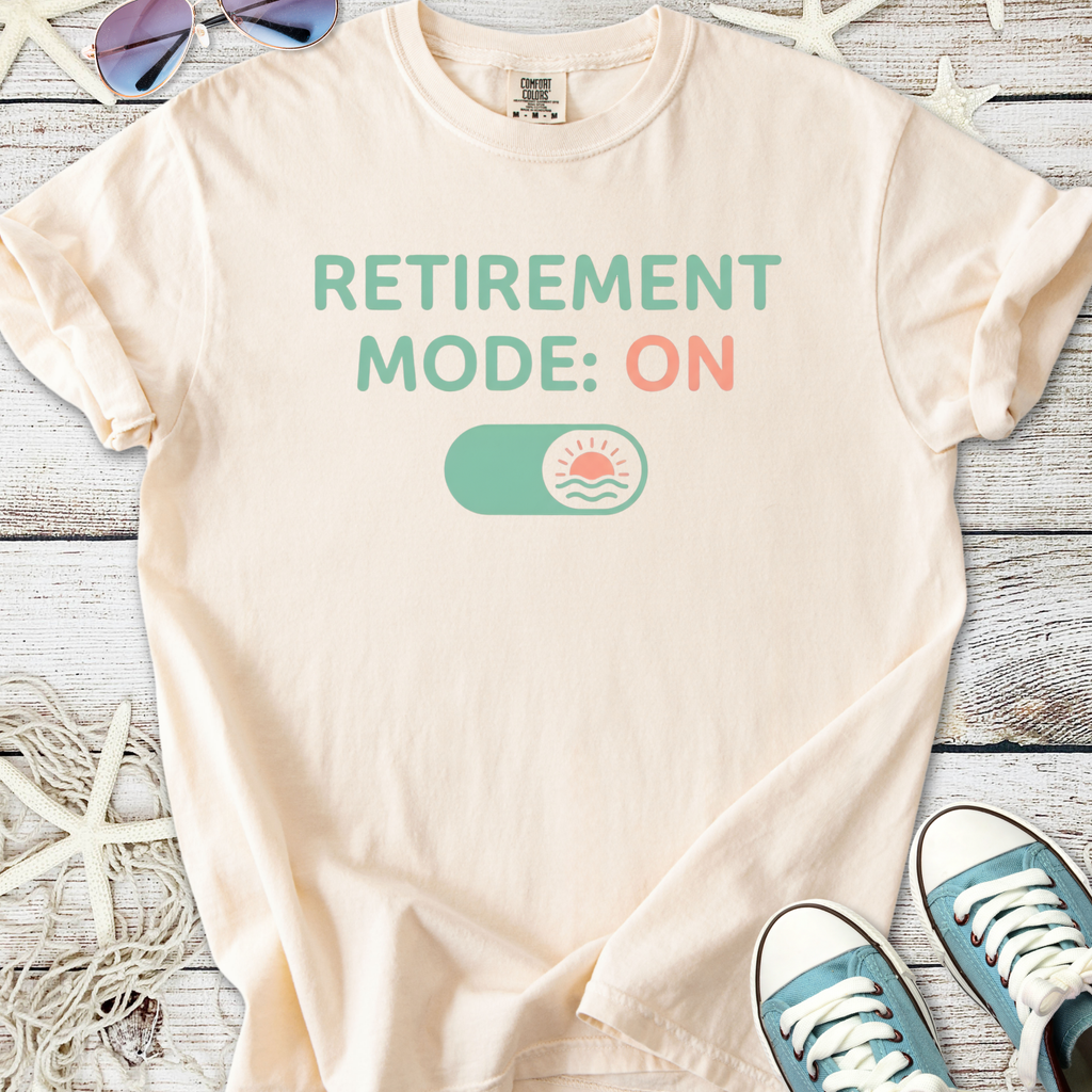 Cream t-shirt with 'RETIREMENT MODE: ON' graphic, perfect for casual wear or retirement celebrations.