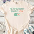 Cream t-shirt with 'RETIREMENT MODE: ON' graphic, perfect for casual wear or retirement celebrations.