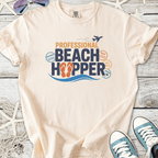Light beige t-shirt with 'Professional Beach Hopper' graphic, featuring beach destinations and flip flop design.