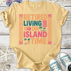 Beige graphic tee featuring 'Retired Living on Island Time' design with tropical elements.