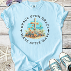 Light blue t-shirt with floral cross design, featuring 'Grace Upon Grace' text, perfect for casual wear.