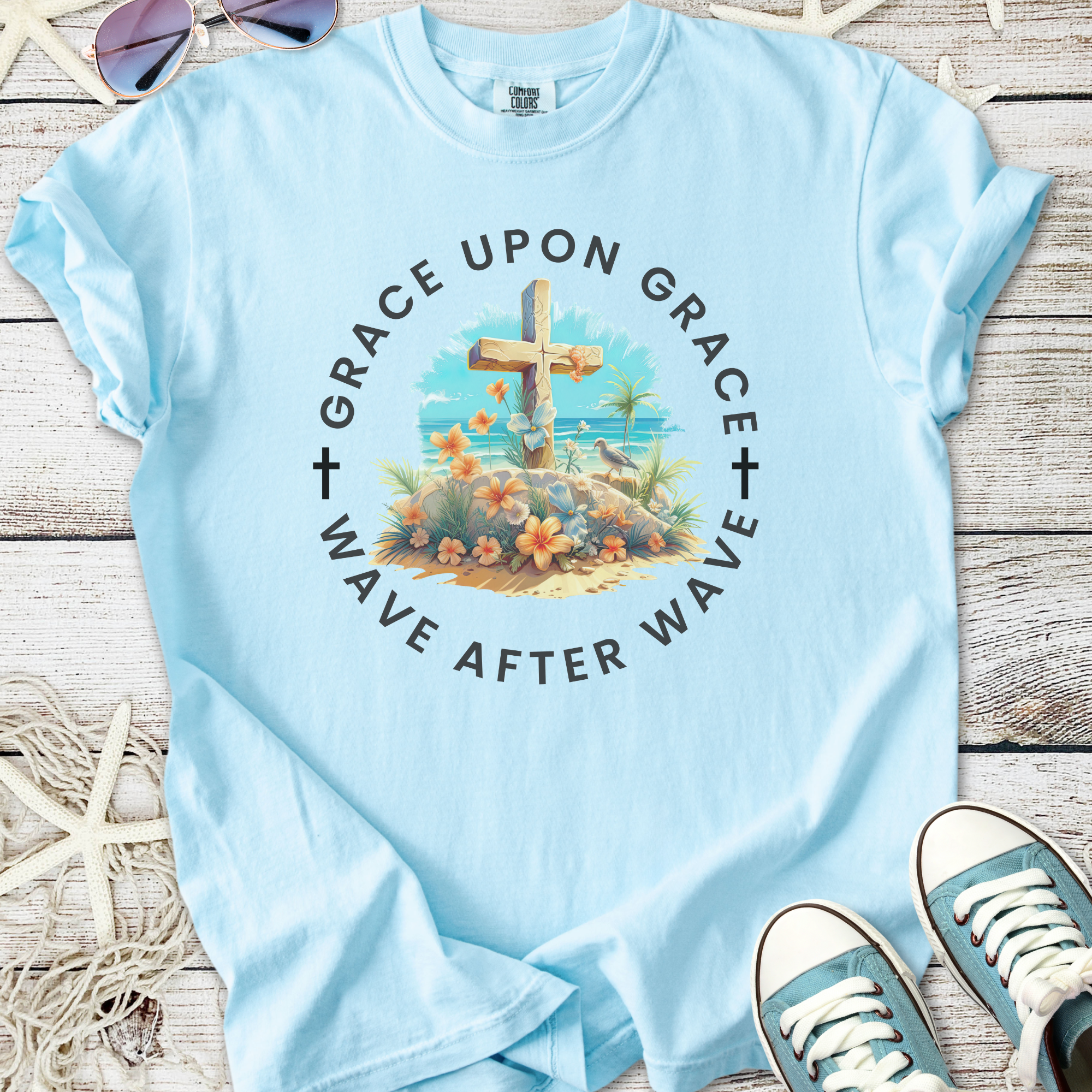 Light blue t-shirt with floral cross design, featuring 'Grace Upon Grace' text, perfect for casual wear.