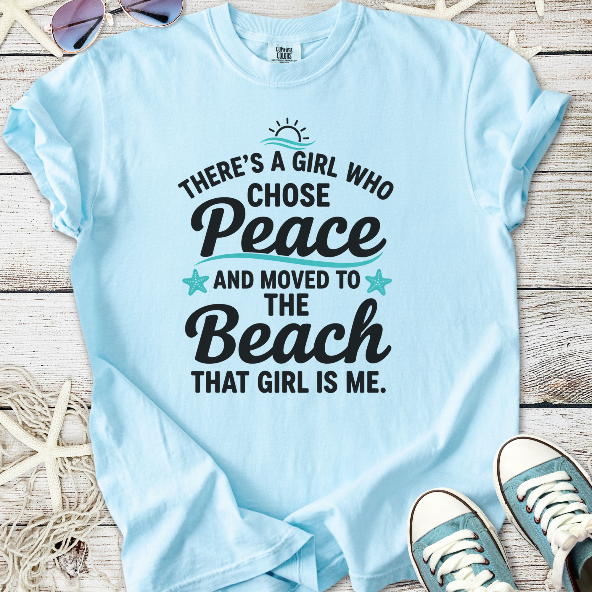 Light blue t-shirt with 'There's a girl who chose Peace and moved to the Beach' text design.