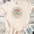 Peach t-shirt with beach-themed dog graphic, featuring 'Life is Short, Fetch It at the Beach' slogan.