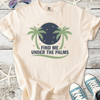 Cream graphic t-shirt with 'Find Me Under The Palms' design and palm tree illustration.