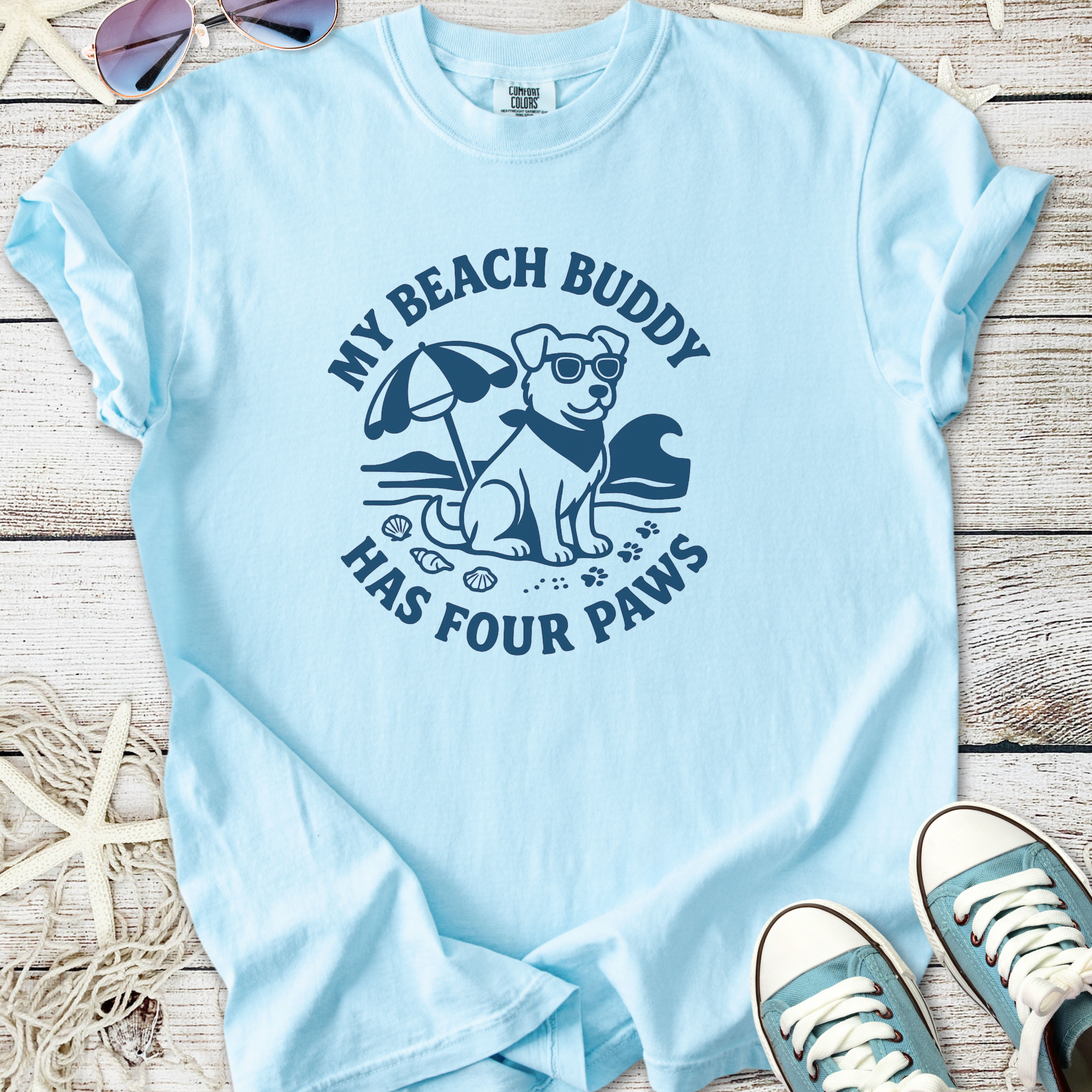 Light blue t-shirt featuring a beach-themed dog graphic with the text 'My Beach Buddy Has Four Paws'