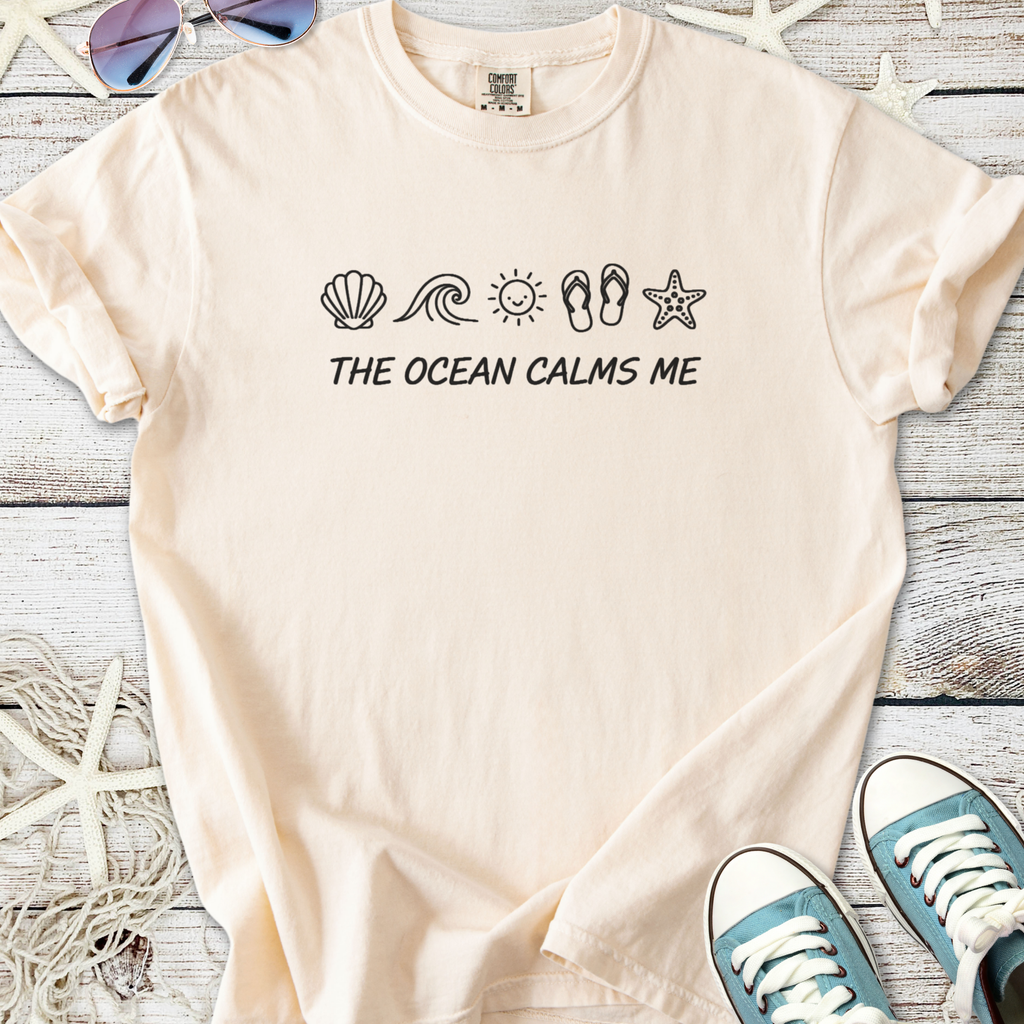 Beige cotton t-shirt with ocean-themed print and 'The Ocean Calms Me' slogan, perfect for beach lovers.