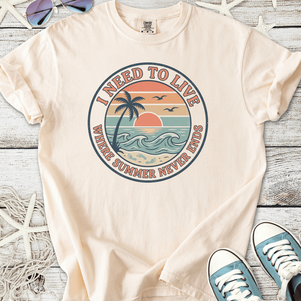 Men's beige t-shirt with 'I Need to Live' graphic, featuring a sunset and palm tree design.