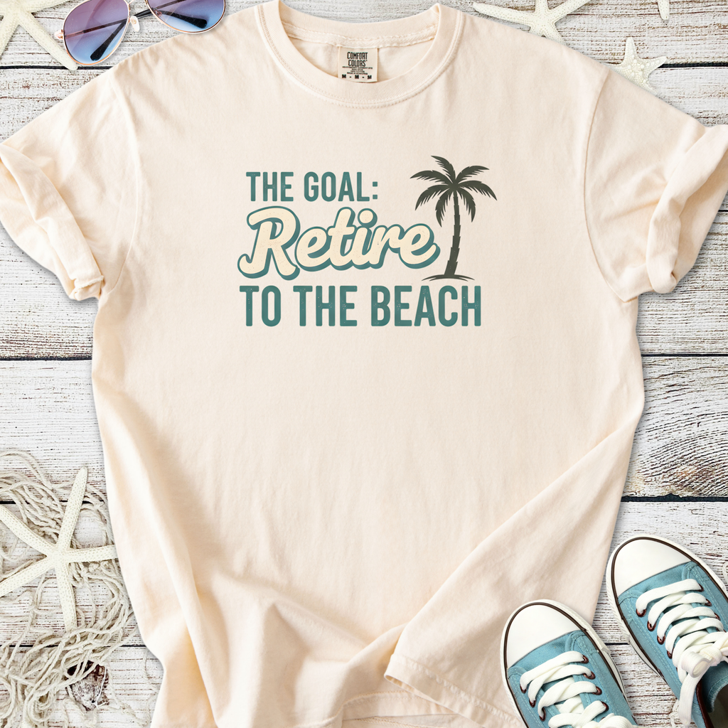 Light beige t-shirt featuring palm tree graphic and 'Retire to the Beach' quote for relaxed wear.