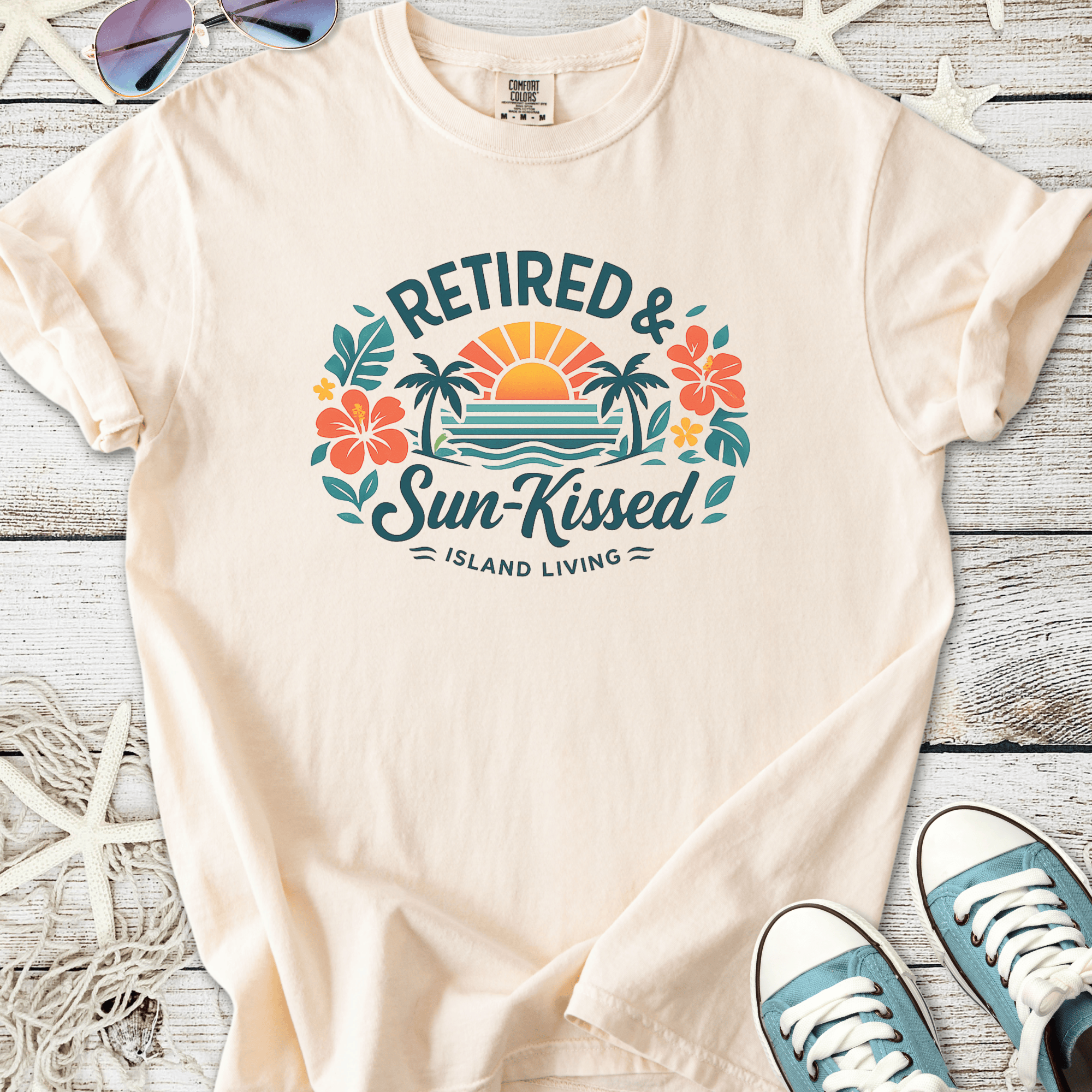 Cream cotton t-shirt with 'Retired & Sun-Kissed' graphic, tropical design and relaxed fit.
