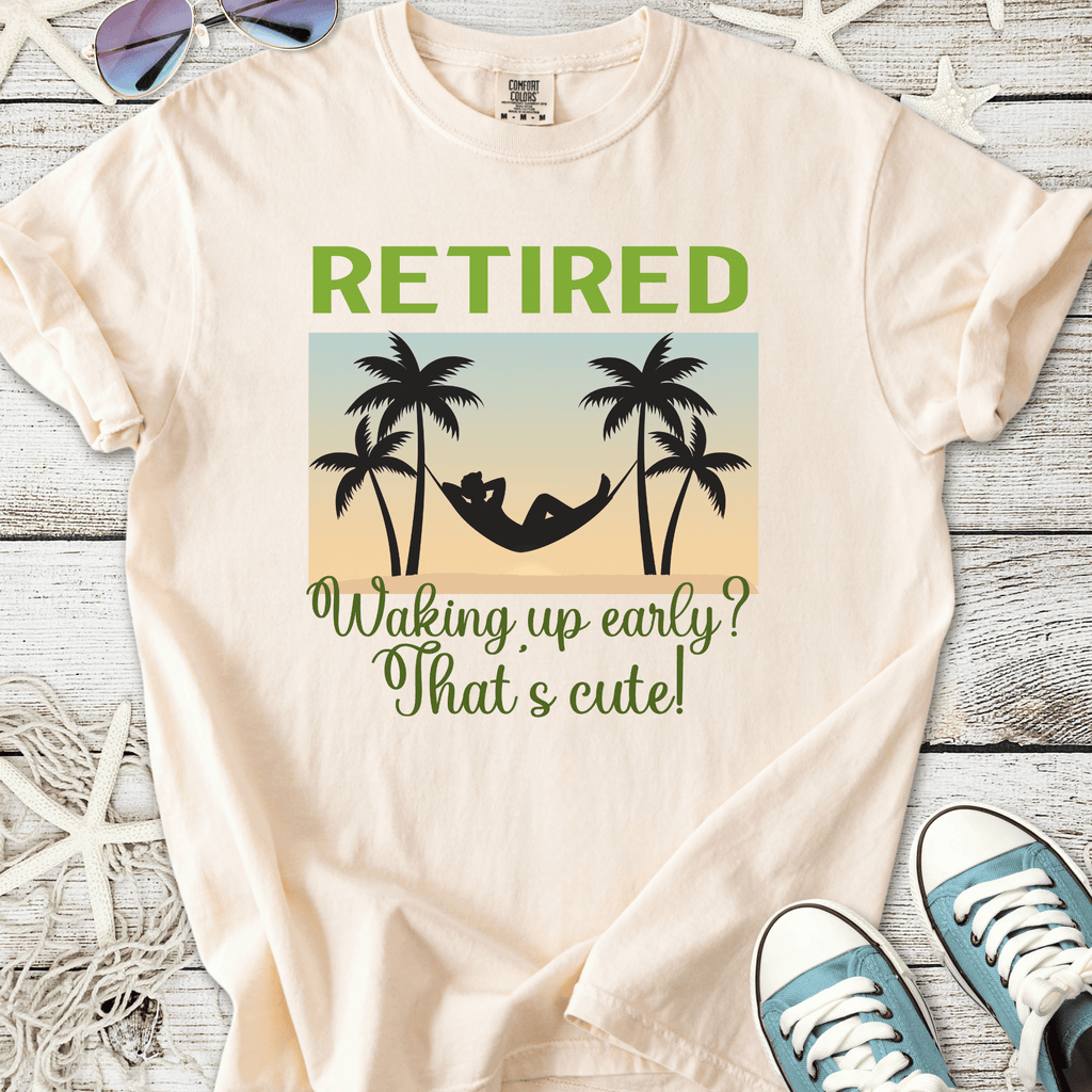 Cream retirement t-shirt with palm tree graphics and humorous text about waking up early.