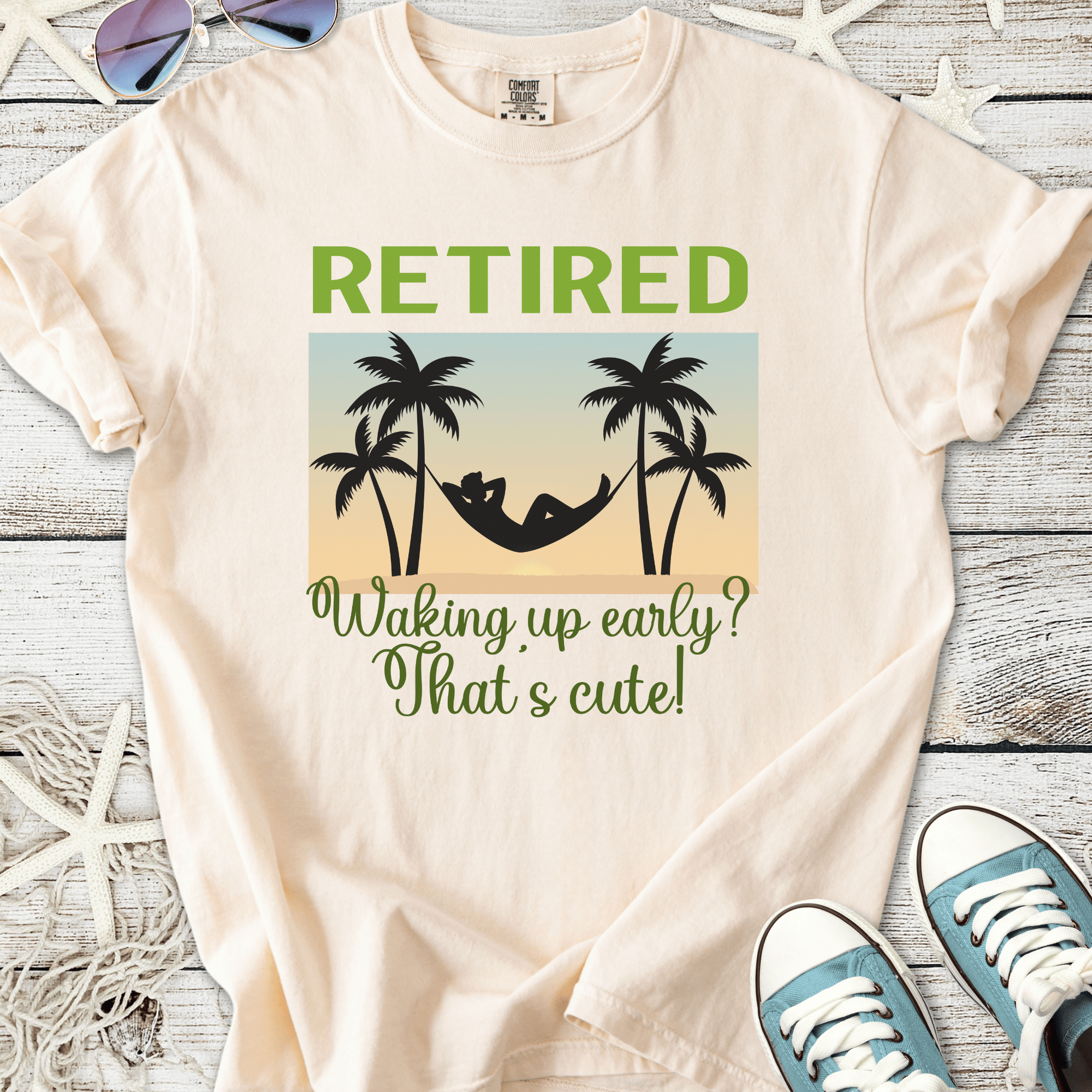 Cream retirement t-shirt with palm tree graphics and humorous text about waking up early.
