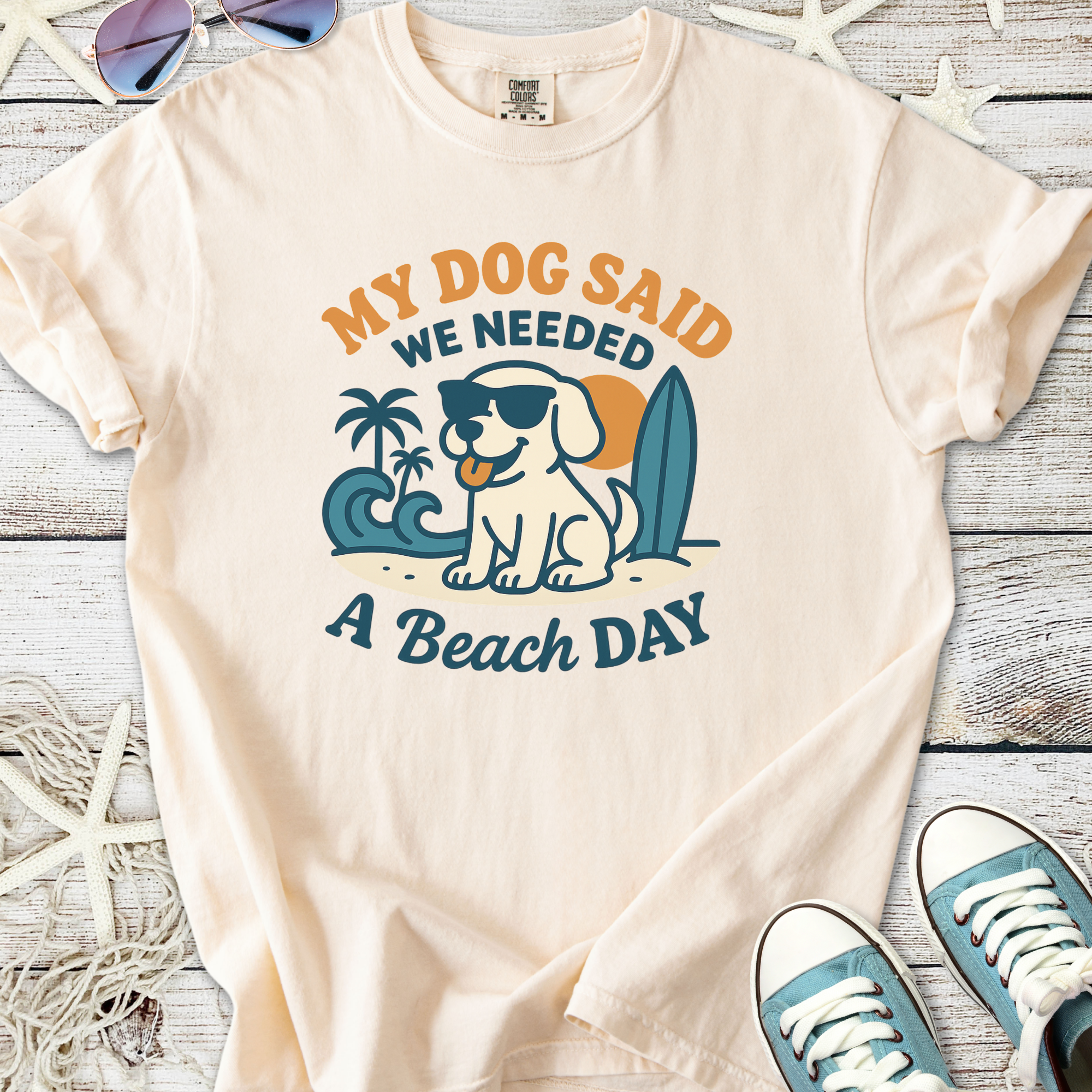 Light beige t-shirt featuring fun dog graphic with sunglasses, beach theme, and quote about beach day.