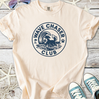 Cream t-shirt featuring 'Wave Chaser Club' graphic with a dog and ocean waves, perfect for beach lovers.